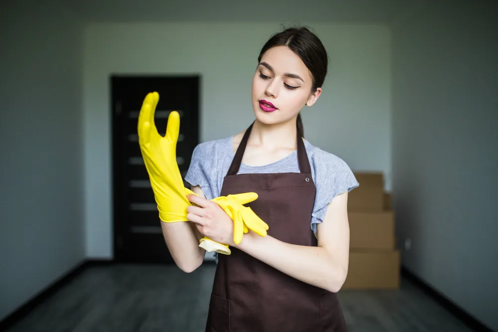 Maid in Malaysia putting on Gloves for cleaning purposes