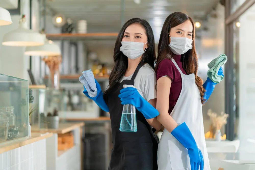 two maids holding cleaning equipements for cleaning in malaysia